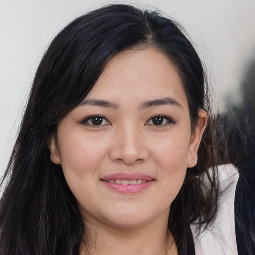 Joyful asian young-adult female with long  brown hair and brown eyes