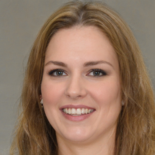 Joyful white young-adult female with long  brown hair and brown eyes