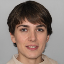 Joyful white young-adult female with medium  brown hair and grey eyes