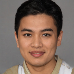 Joyful latino young-adult male with short  brown hair and brown eyes