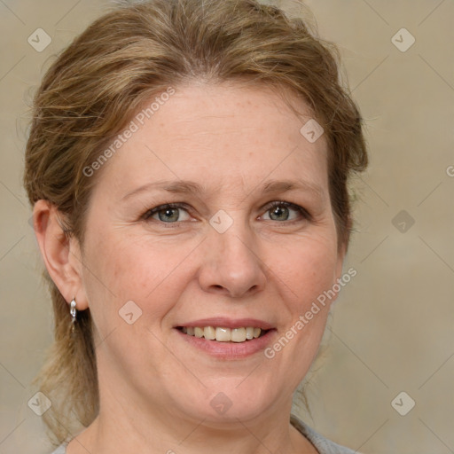 Joyful white adult female with medium  brown hair and grey eyes