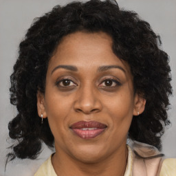 Joyful black adult female with medium  brown hair and brown eyes