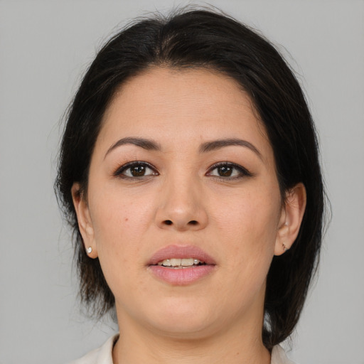 Joyful asian adult female with medium  brown hair and brown eyes