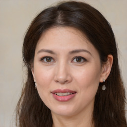 Joyful white adult female with long  brown hair and brown eyes