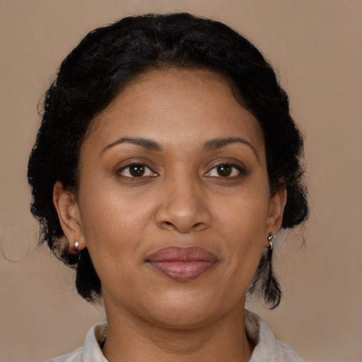 Joyful black adult female with medium  brown hair and brown eyes