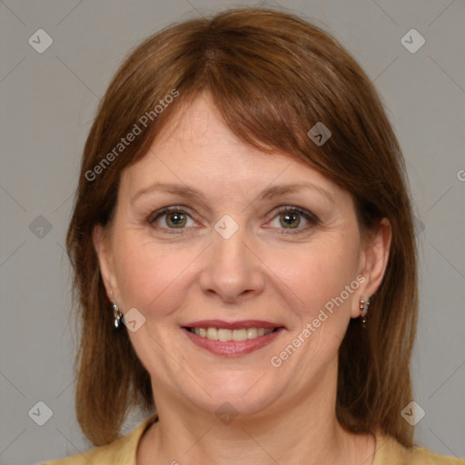 Joyful white adult female with medium  brown hair and grey eyes