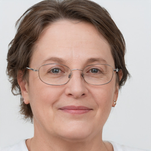 Joyful white adult female with short  brown hair and grey eyes