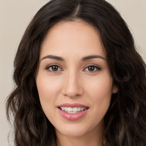 Joyful white young-adult female with long  brown hair and brown eyes