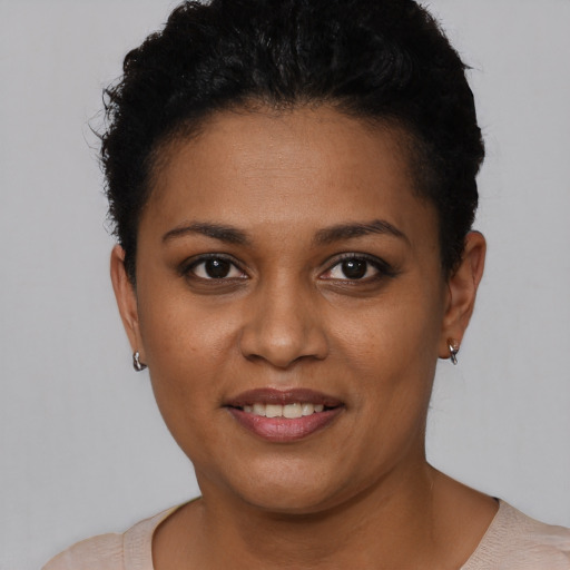 Joyful black young-adult female with short  brown hair and brown eyes