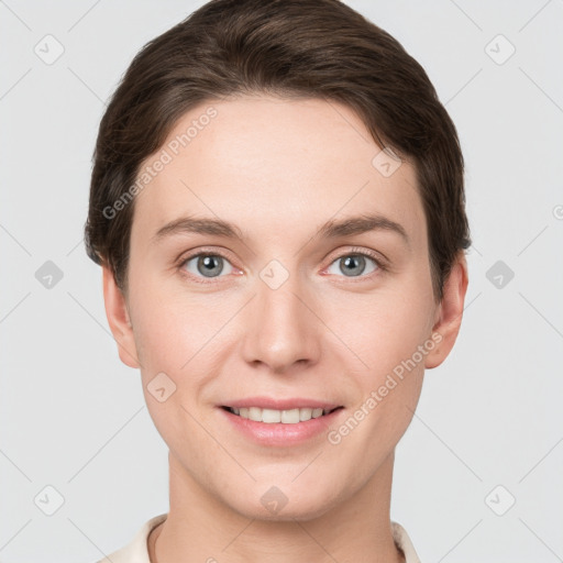 Joyful white young-adult female with short  brown hair and grey eyes