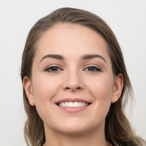 Joyful white young-adult female with long  brown hair and grey eyes