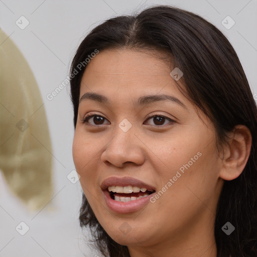 Joyful asian young-adult female with long  brown hair and brown eyes