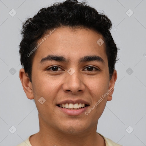 Joyful latino young-adult male with short  brown hair and brown eyes