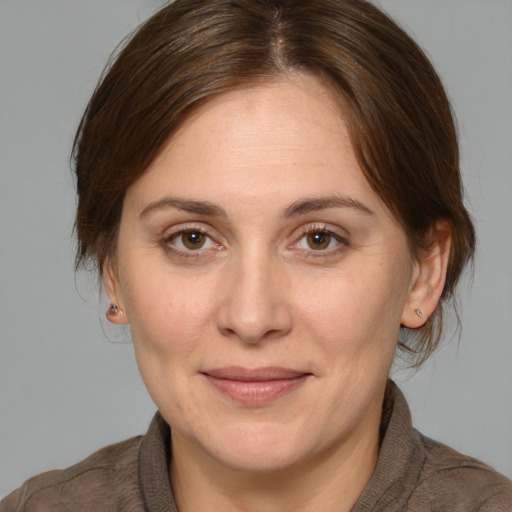 Joyful white adult female with medium  brown hair and brown eyes