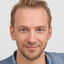 Joyful white adult male with short  brown hair and blue eyes