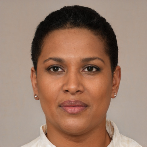 Joyful latino young-adult female with short  brown hair and brown eyes