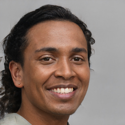 Joyful black young-adult male with short  brown hair and brown eyes