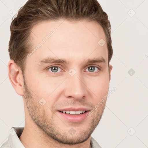 Joyful white young-adult male with short  brown hair and grey eyes