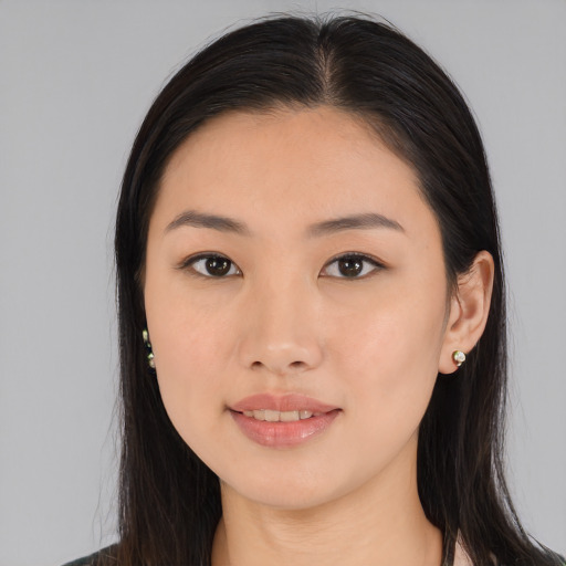 Joyful asian young-adult female with long  black hair and brown eyes