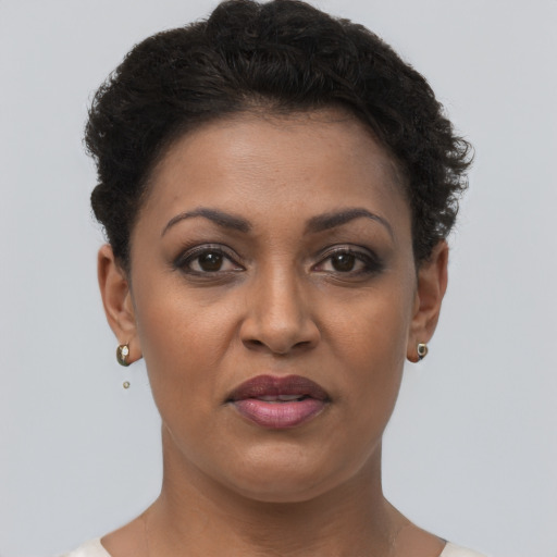 Joyful black adult female with short  brown hair and brown eyes