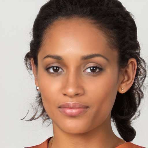 Joyful latino young-adult female with medium  brown hair and brown eyes