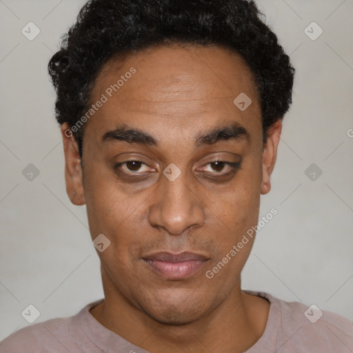 Joyful black adult male with short  black hair and brown eyes