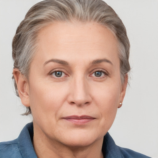 Joyful white adult female with medium  brown hair and grey eyes