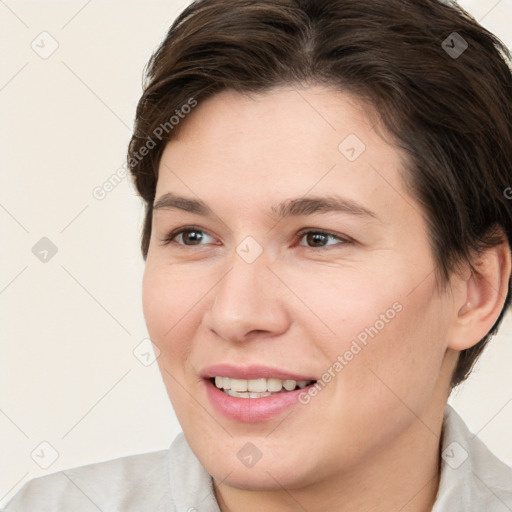 Joyful white young-adult female with short  brown hair and brown eyes