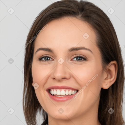 Joyful white young-adult female with long  brown hair and brown eyes