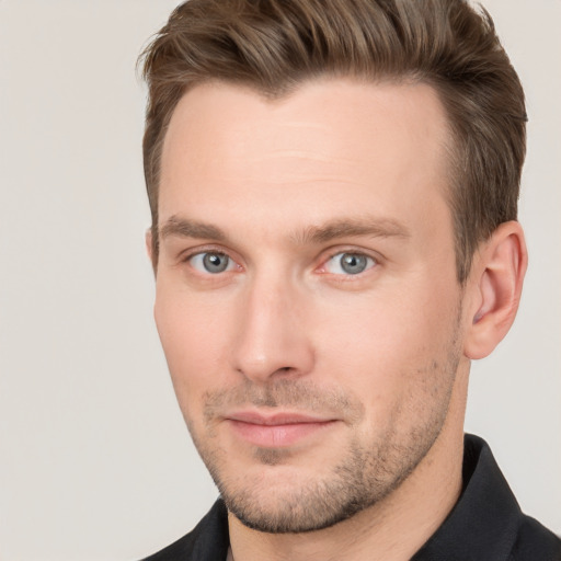 Joyful white young-adult male with short  brown hair and grey eyes