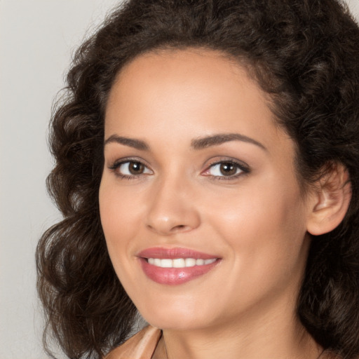 Joyful white young-adult female with long  brown hair and brown eyes