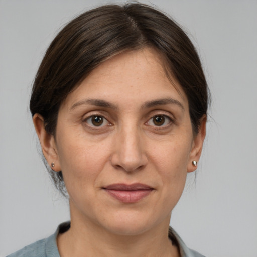 Joyful white adult female with medium  brown hair and brown eyes