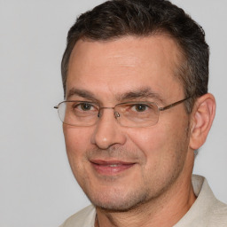 Joyful white adult male with short  brown hair and brown eyes