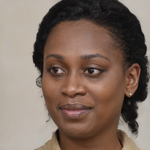 Joyful black young-adult female with medium  black hair and brown eyes