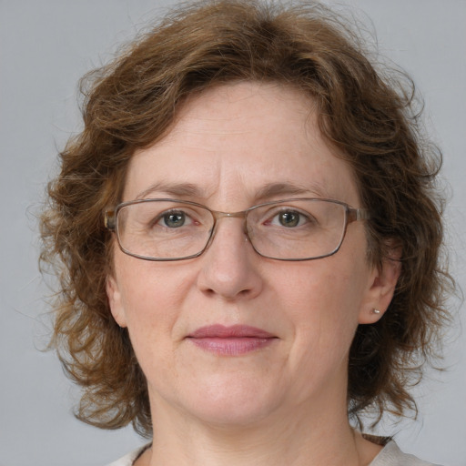 Joyful white middle-aged female with medium  brown hair and blue eyes