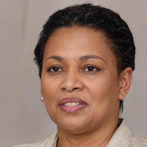 Joyful black adult female with short  black hair and brown eyes