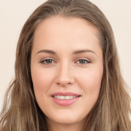 Joyful white young-adult female with long  brown hair and brown eyes