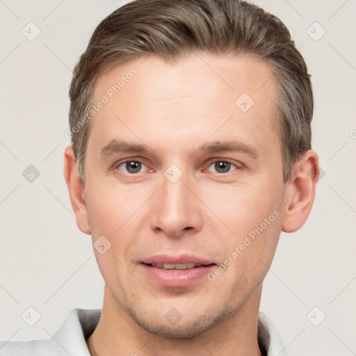 Joyful white young-adult male with short  brown hair and brown eyes