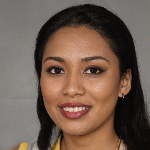 Joyful latino young-adult female with long  black hair and brown eyes