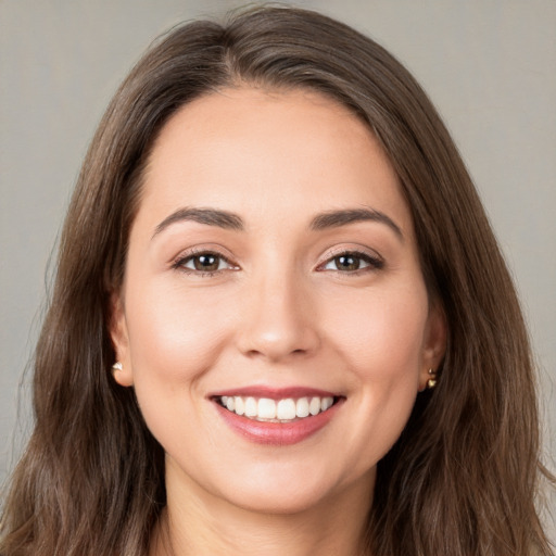 Joyful white young-adult female with long  brown hair and brown eyes