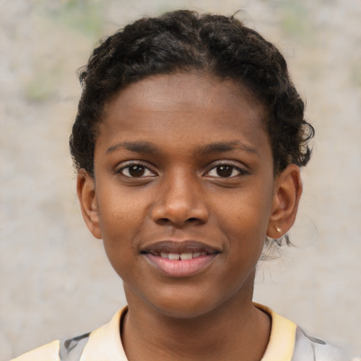 Joyful black child female with short  brown hair and brown eyes
