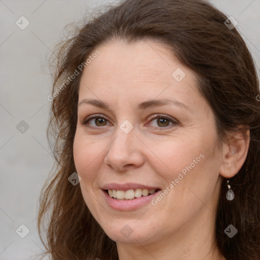 Joyful white adult female with long  brown hair and brown eyes