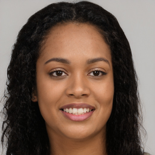 Joyful latino young-adult female with long  black hair and brown eyes