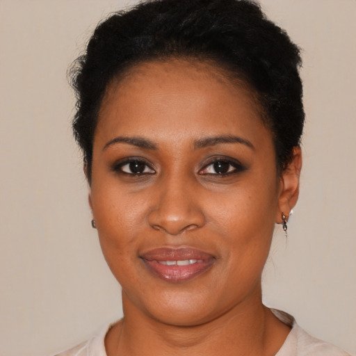 Joyful black young-adult female with short  brown hair and brown eyes