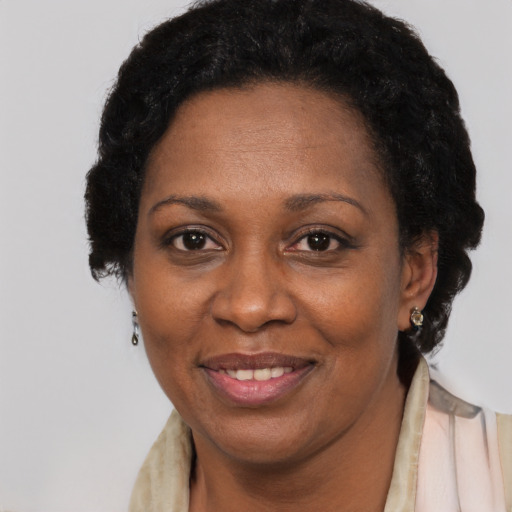 Joyful black adult female with short  black hair and brown eyes