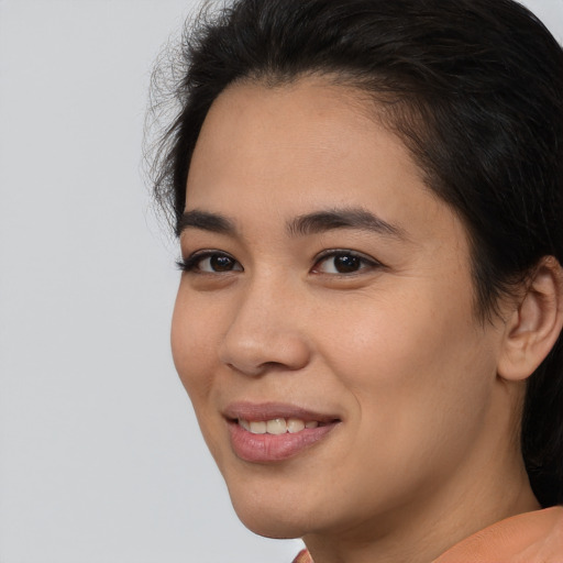 Joyful latino young-adult female with medium  brown hair and brown eyes