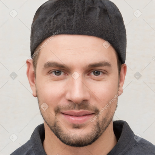 Joyful white young-adult male with short  brown hair and grey eyes