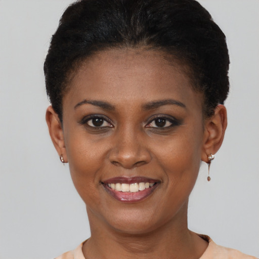 Joyful black young-adult female with short  brown hair and brown eyes