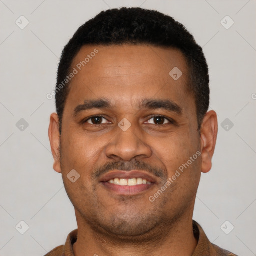 Joyful latino young-adult male with short  black hair and brown eyes