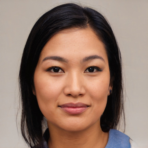 Joyful latino young-adult female with medium  black hair and brown eyes